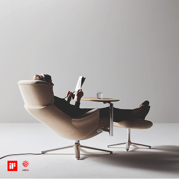 Individual reading on the Humanscale Diffrient Lounge with ottoman